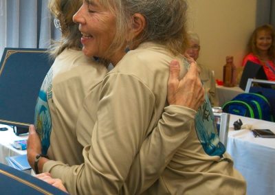 Phyllis receiving hug from CHAT graduate